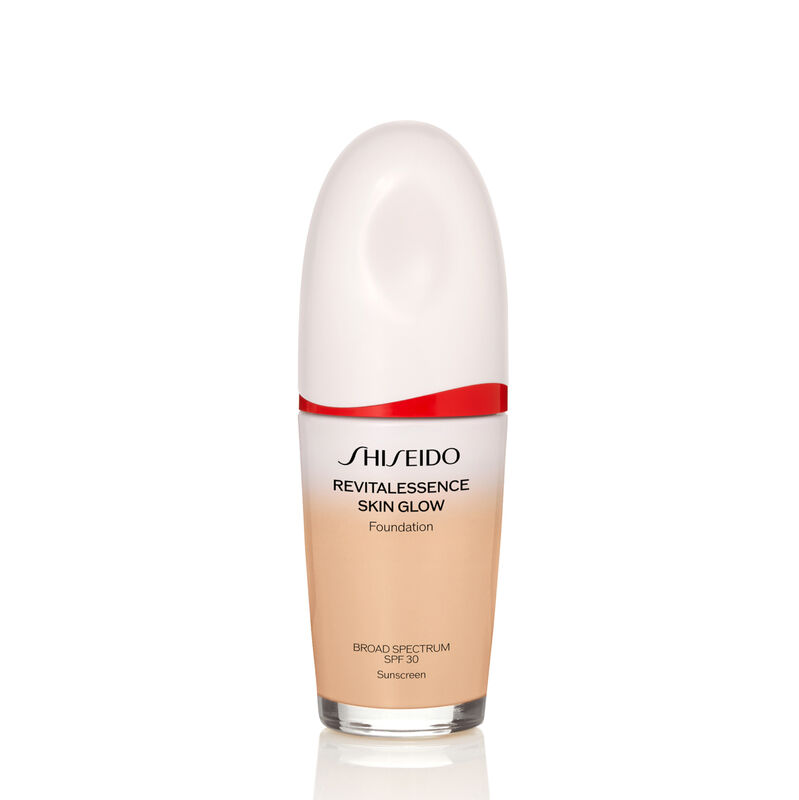An oval-shaped bottle of Shiseido Revitalessence Skin Glow Foundation SPF 30 in shade 150 Lace. The label on the bottle is white with a red accent. The text on the label reads the product&rsquo;s title, and its sunscreen protection.