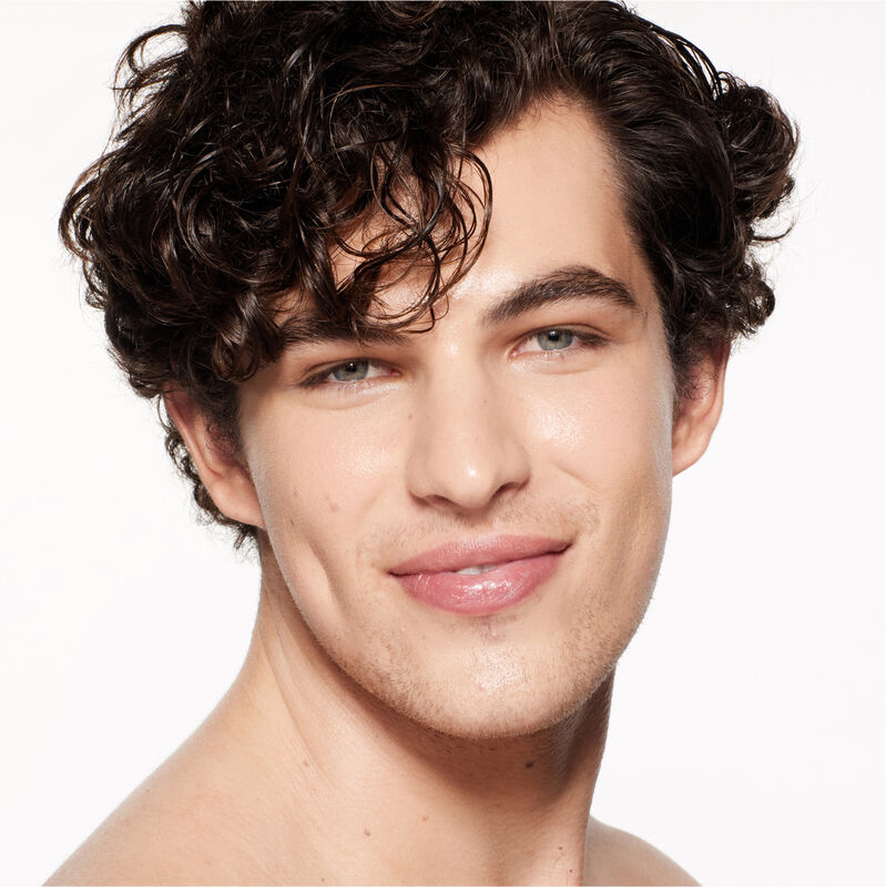 "A headshot of a model wearing the Shiseido Revitalessence Skin Glow Foundation SPF 30 in shade 230 Alder. The models&rsquo; skin appears more smooth and glowy with the foundation's medium-coverage finish.  "