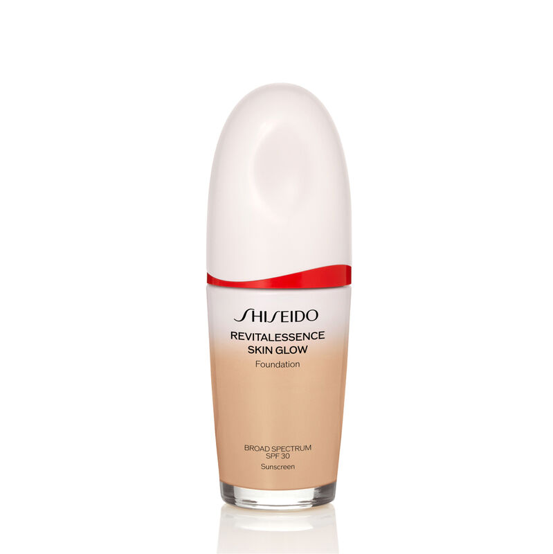 An oval-shaped bottle of Shiseido Revitalessence Skin Glow Foundation SPF 30 in shade 240 Quartz. The label on the bottle is white with a red accent. The text on the label reads the product&rsquo;s title, and its sunscreen protection.
