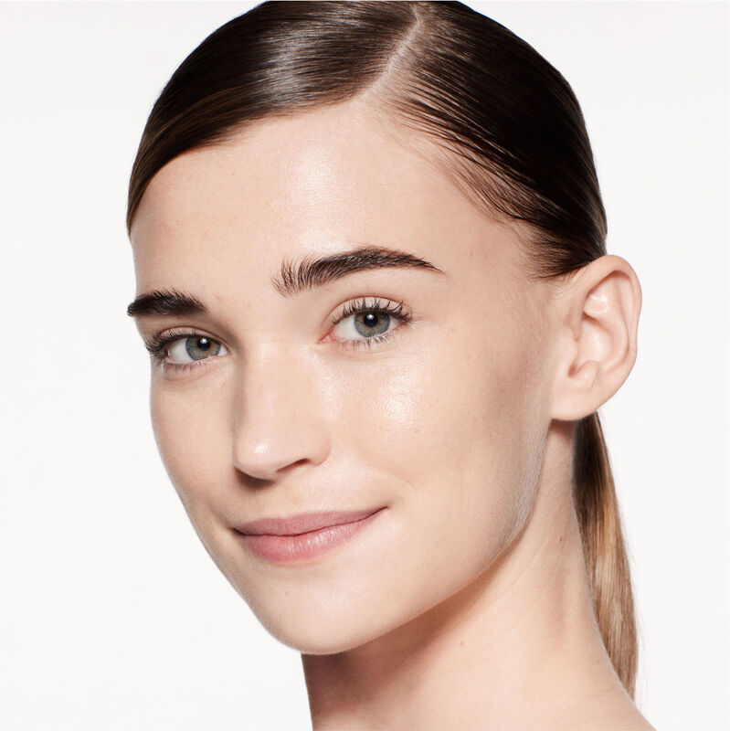 "A headshot of a model wearing the Shiseido Revitalessence Skin Glow Foundation SPF 30 in shade 130 Opal. The models&rsquo; skin appears more smooth and glowy with the foundation's medium-coverage finish.  "