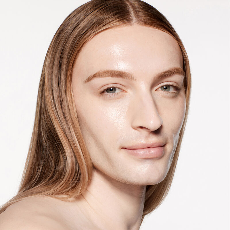"A headshot of a model wearing the Shiseido Revitalessence Skin Glow Foundation SPF 30 in shade 120 Ivory. The models&rsquo; skin appears more smooth and glowy with the foundation's medium-coverage finish. "