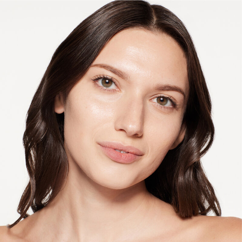 A headshot of a model wearing the Shiseido Revitalessence Skin Glow Foundation SPF 30 in shade 240 Quartz. The models&rsquo; skin appears more smooth and glowy with the foundation's medium-coverage finish.