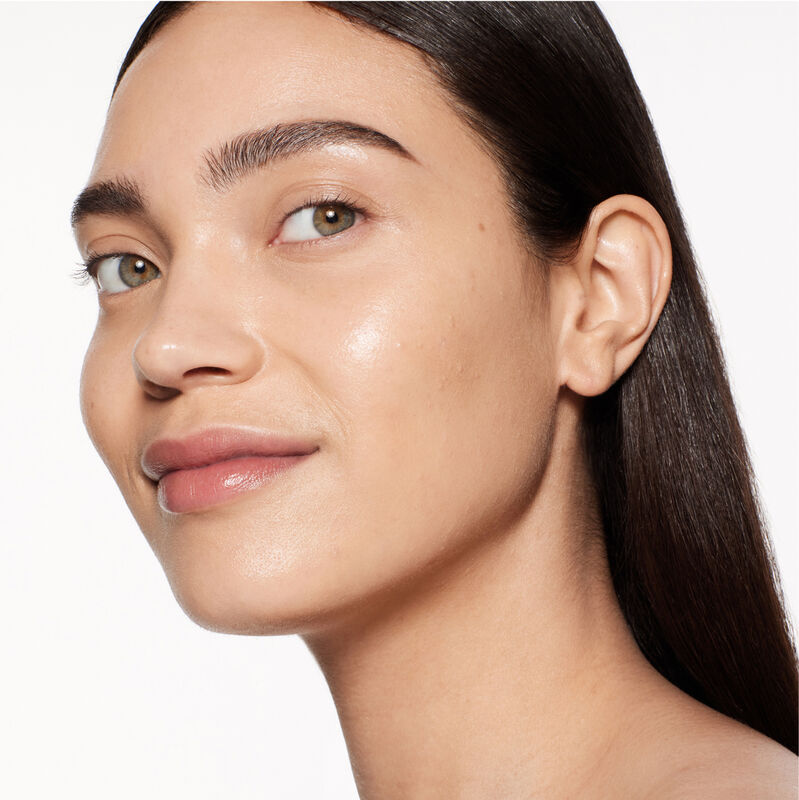 "A headshot of a model wearing the Shiseido Revitalessence Skin Glow Foundation SPF 30 in shade 330 Bamboo. The models&rsquo; skin appears more smooth and glowy with the foundation's medium-coverage finish.  "