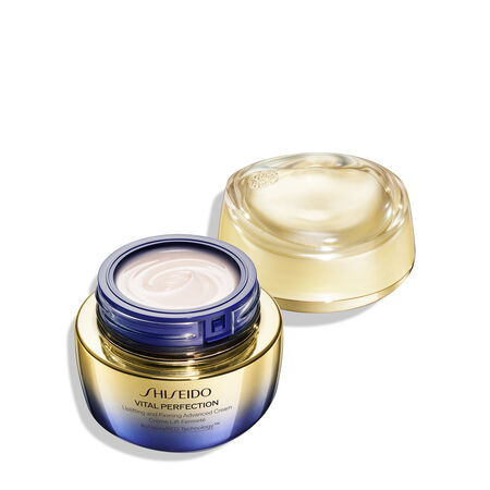 A round, gold-and-purple-colored jar of Shiseido Vital Perfection Uplifting and Firming Advanced Cream. The closed jar features the Shiseido logo, product name, and the words "ReNeuraRED Technology." 