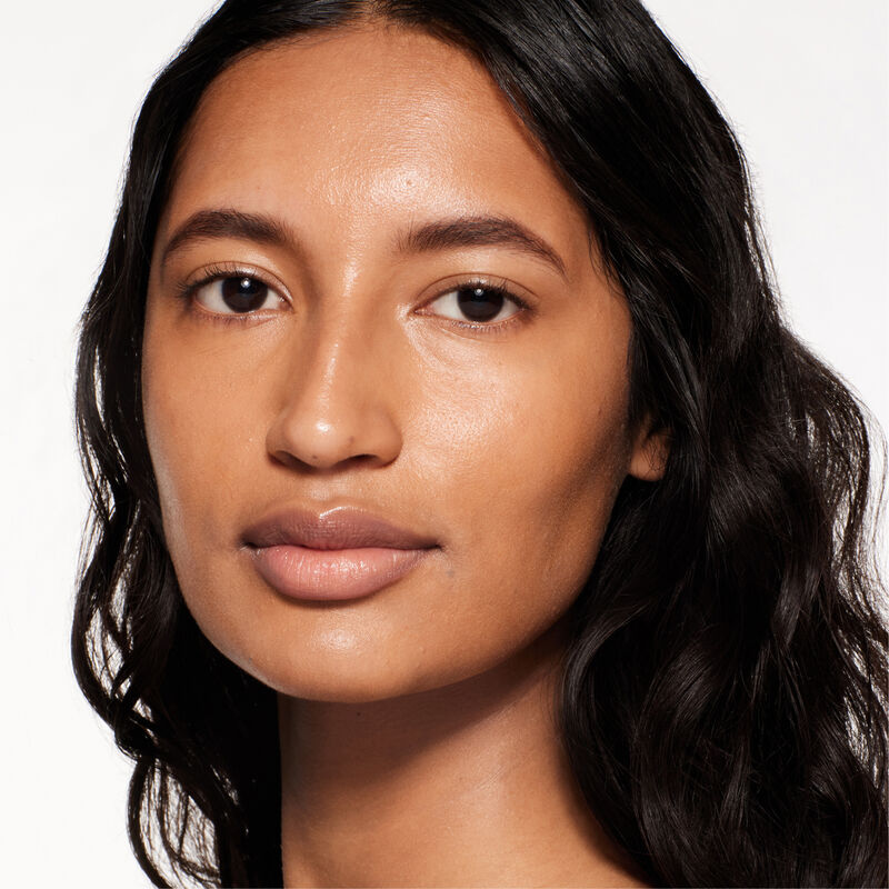 "A headshot of a model wearing the Shiseido Revitalessence Skin Glow Foundation SPF 30 in shade 410 Sunstone. The models&rsquo; skin appears more smooth and glowy with the foundation's medium-coverage finish.  "
