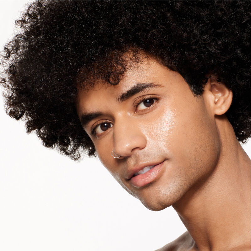 "A headshot of a model wearing the Shiseido Revitalessence Skin Glow Foundation SPF 30 in shade 360 Citrine. The models&rsquo; skin appears more smooth and glowy with the foundation's medium-coverage finish.  "