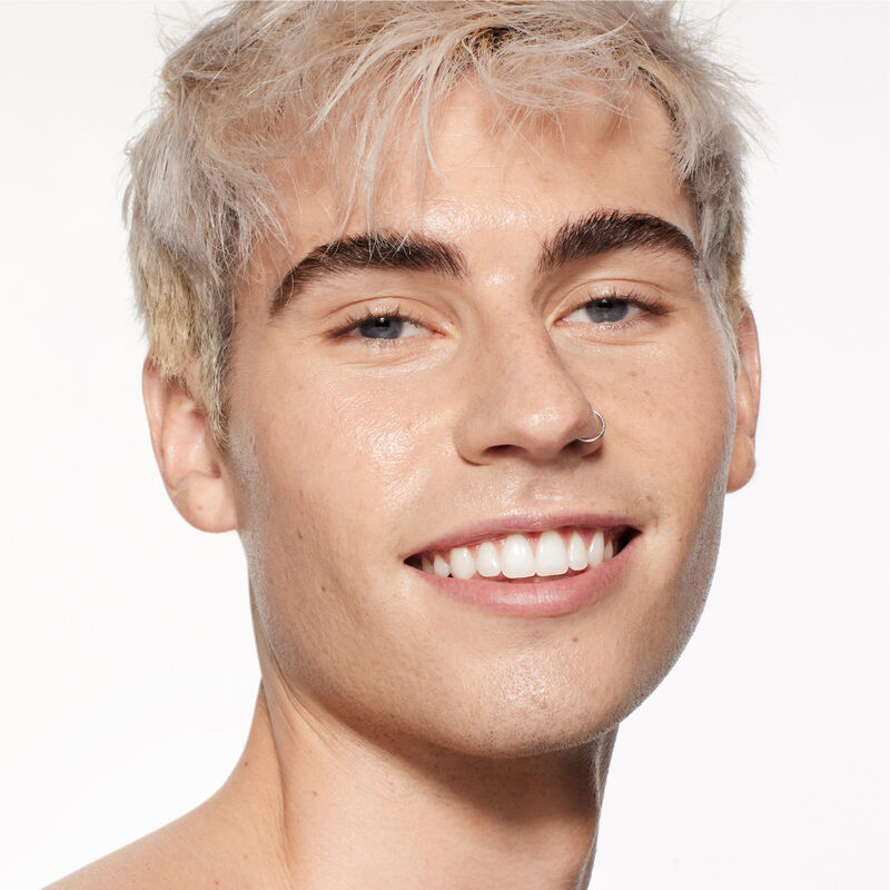 "A headshot of a model wearing the Shiseido Revitalessence Skin Glow Foundation SPF 30 in shade 260 Cashmere. The models&rsquo; skin appears more smooth and glowy with the foundation's medium-coverage finish.  "