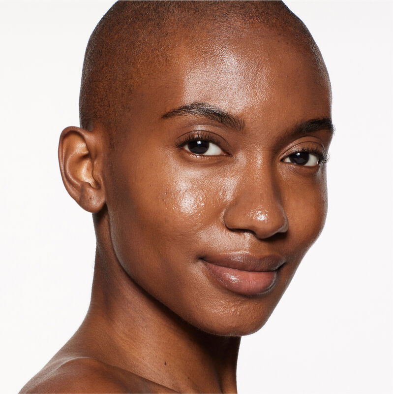 "A headshot of a model wearing the Shiseido Revitalessence Skin Glow Foundation SPF 30 in shade 460 Topaz. The models&rsquo; skin appears more smooth and glowy with the foundation's medium-coverage finish.  "