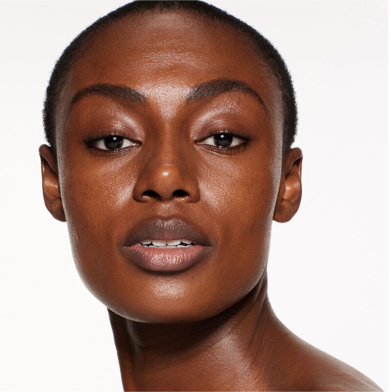 "A headshot of a model wearing the Shiseido Revitalessence Skin Glow Foundation SPF 30 in shade 530 Henna. The models&rsquo; skin appears more smooth and glowy with the foundation's medium-coverage finish.  "